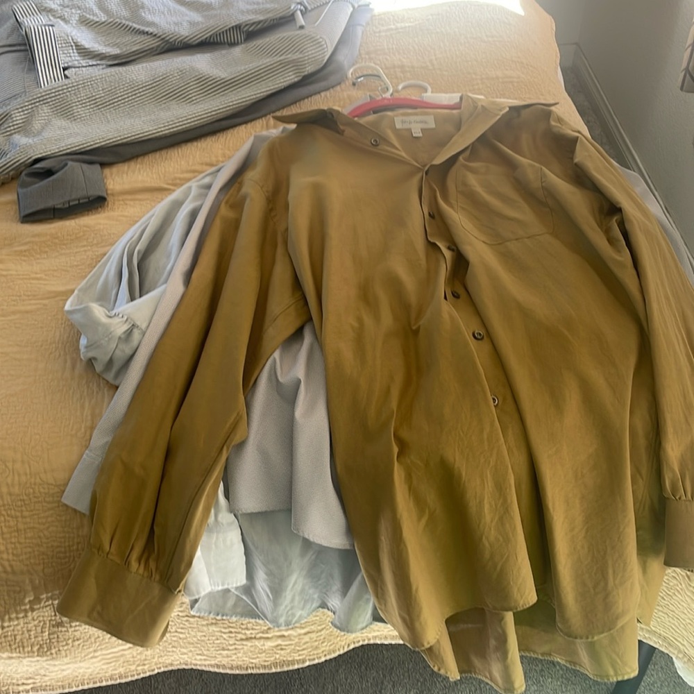 Lots of men’s clothes, suits, nice shirts, and matching pants